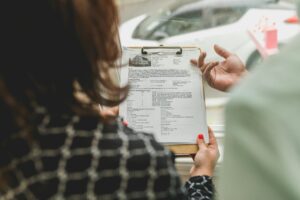 Person Reading and Holding Document Files on Clip Board